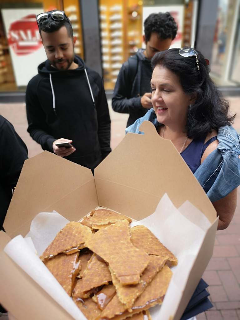 Guest holding Dutch waffles during the Amsterdam Food Tour