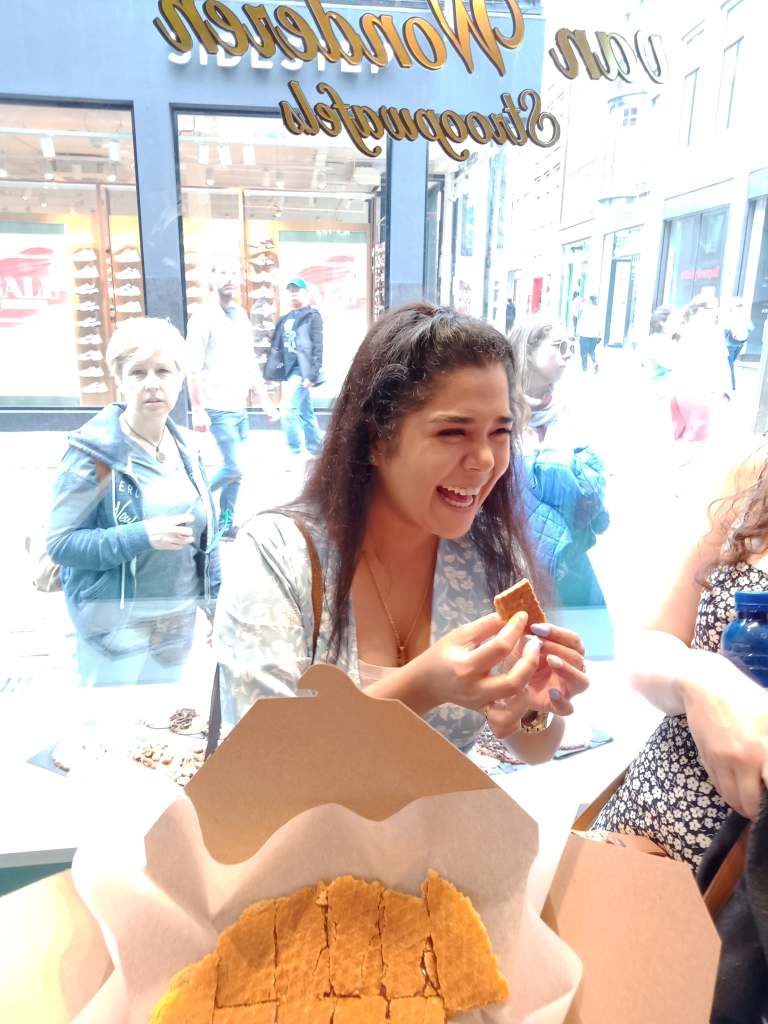 Guest tasting a stroopwafel on the Amsterdam Food Tour