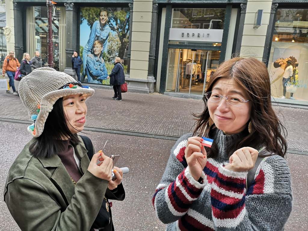 Guests enjoying stroopwafels on an Amsterdam street