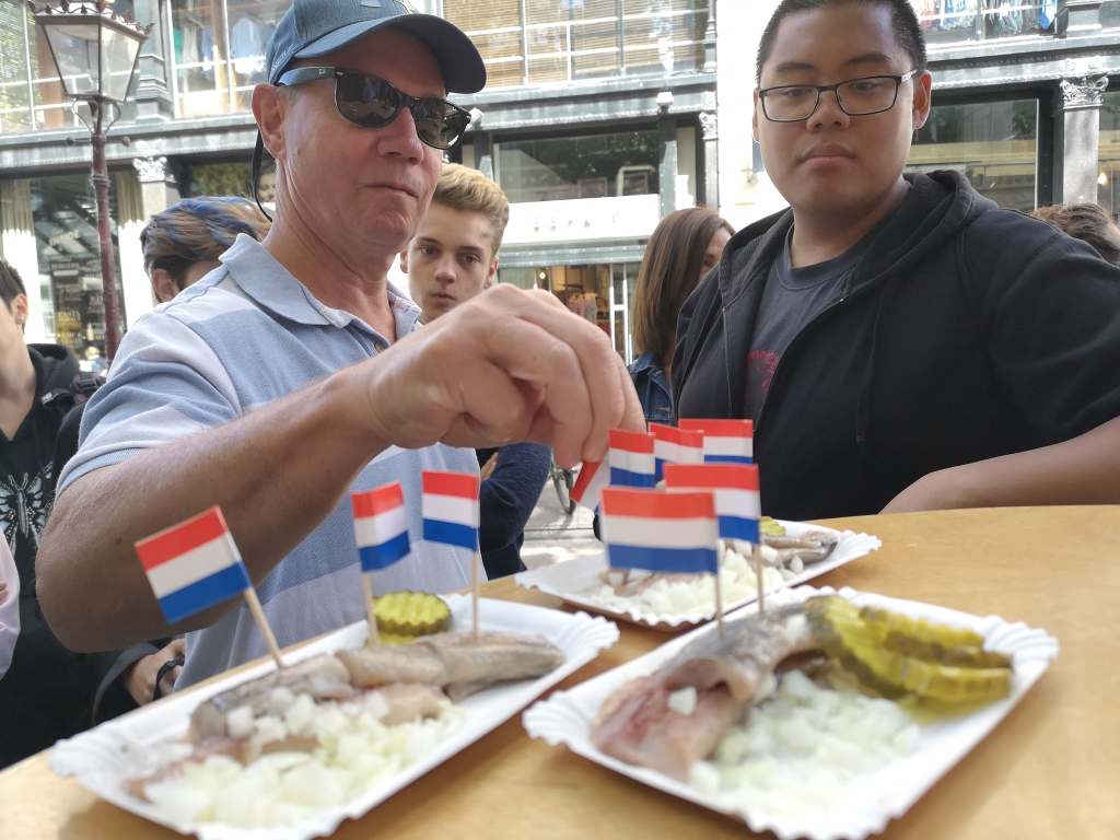 Guests trying Dutch herring in Amsterdam